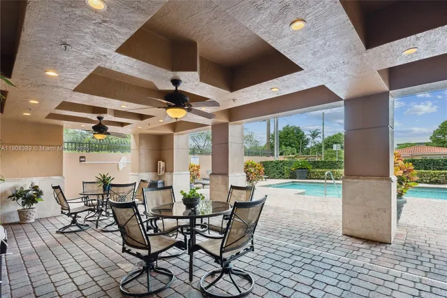 a dining room with furniture and a floor to ceiling window