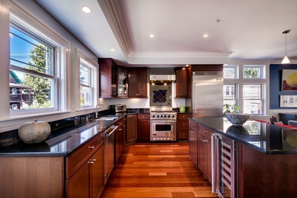 100 Vernon Street, Unit 6 Somerville, MA 02145 - Photo 2 of 10 a kitchen with stainless steel appliances granite countertop sink stove and refrigerator