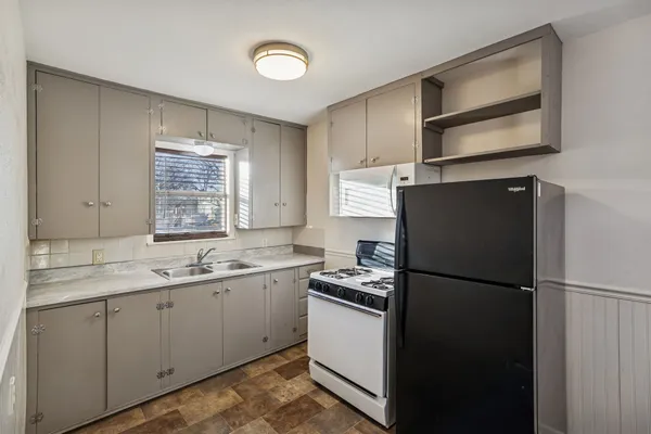 a kitchen with a sink and a refrigerator