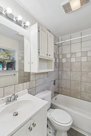 a bathroom with a sink a toilet and bathtub