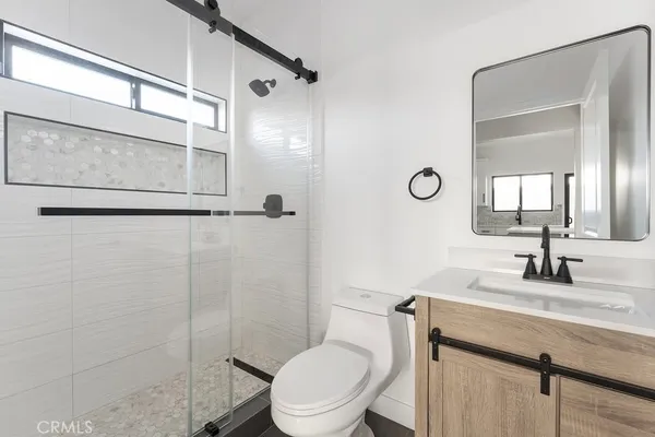 a bathroom with a toilet sink and shower