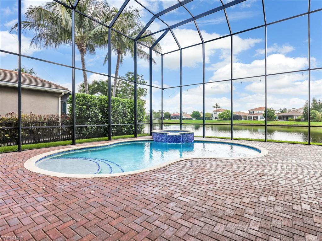 2756 Crystal Way Naples, FL 34119 - Photo 42 of 50 a swimming pool with outdoor seating and yard