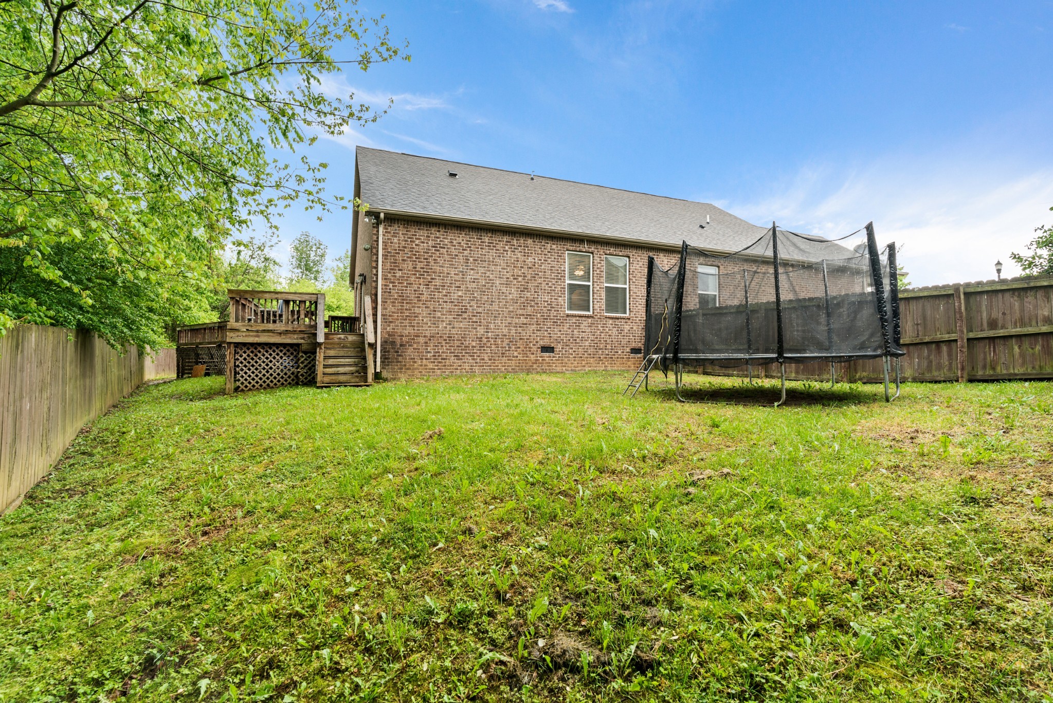 2014 Morton Drive Spring Hill, TN 37174 - Photo 44 of 44 a view of a backyard with plants and a bench