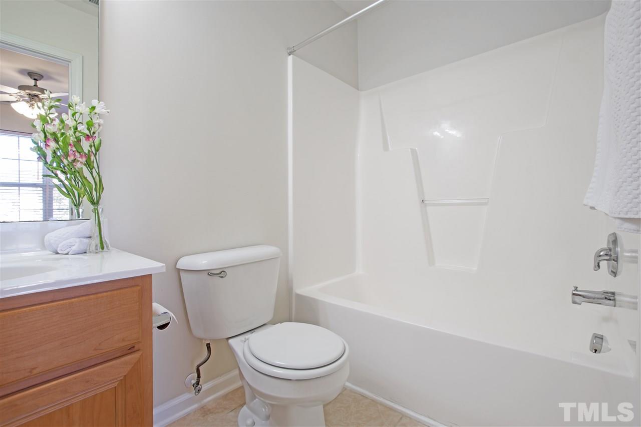 8918 Thornton Garden Lane Raleigh, NC 27616 - Photo 19 of 26 a white toilet sitting next to a bath tub