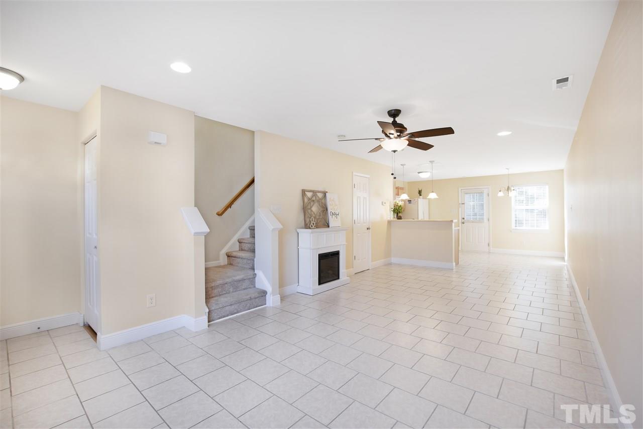 8918 Thornton Garden Lane Raleigh, NC 27616 - Photo 3 of 26 a view of a living room a ceiling fan and entryway