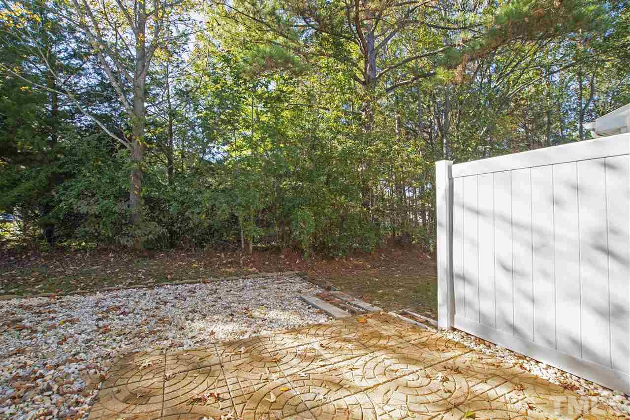 8918 Thornton Garden Lane Raleigh, NC 27616 - Photo 22 of 26 a view of a backyard with a tree