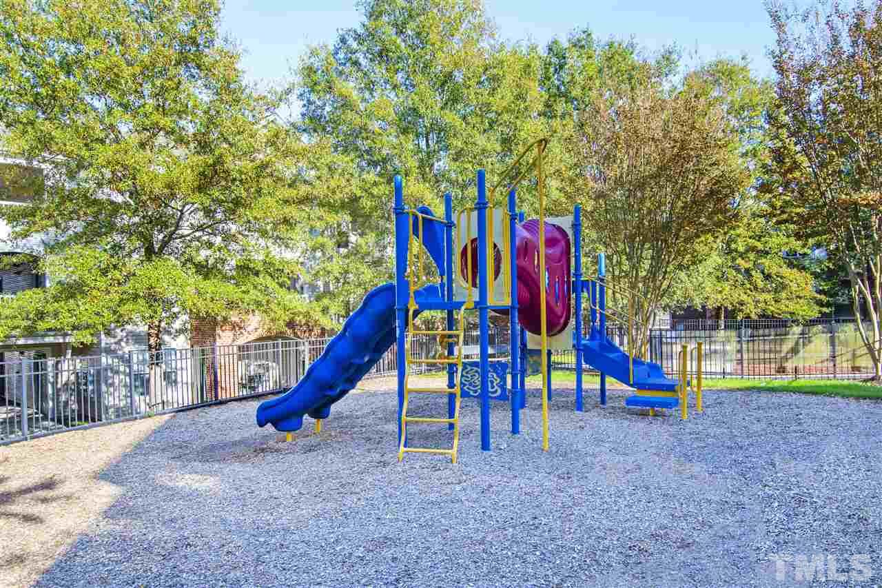 8918 Thornton Garden Lane Raleigh, NC 27616 - Photo 23 of 26 a view of a park with swings and slides