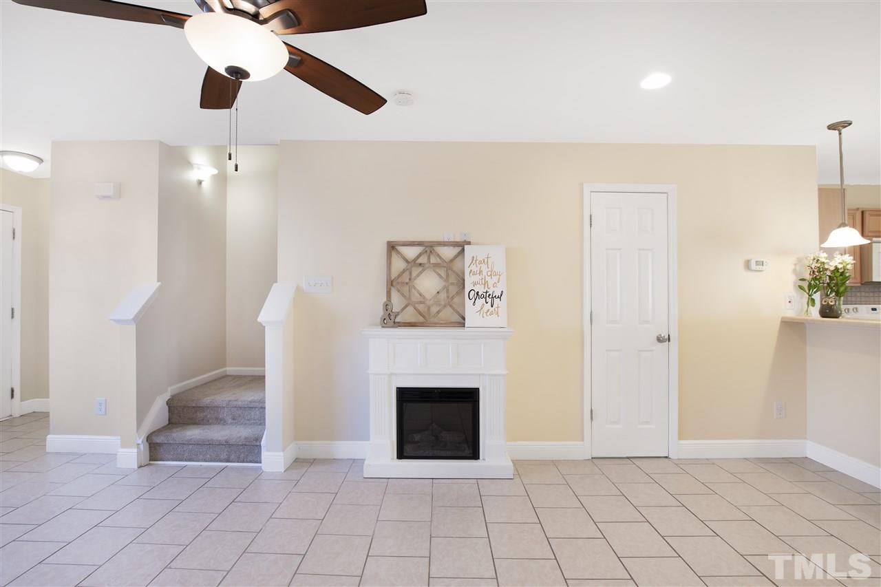 8918 Thornton Garden Lane Raleigh, NC 27616 - Photo 4 of 26 a view of an empty room with a fireplace
