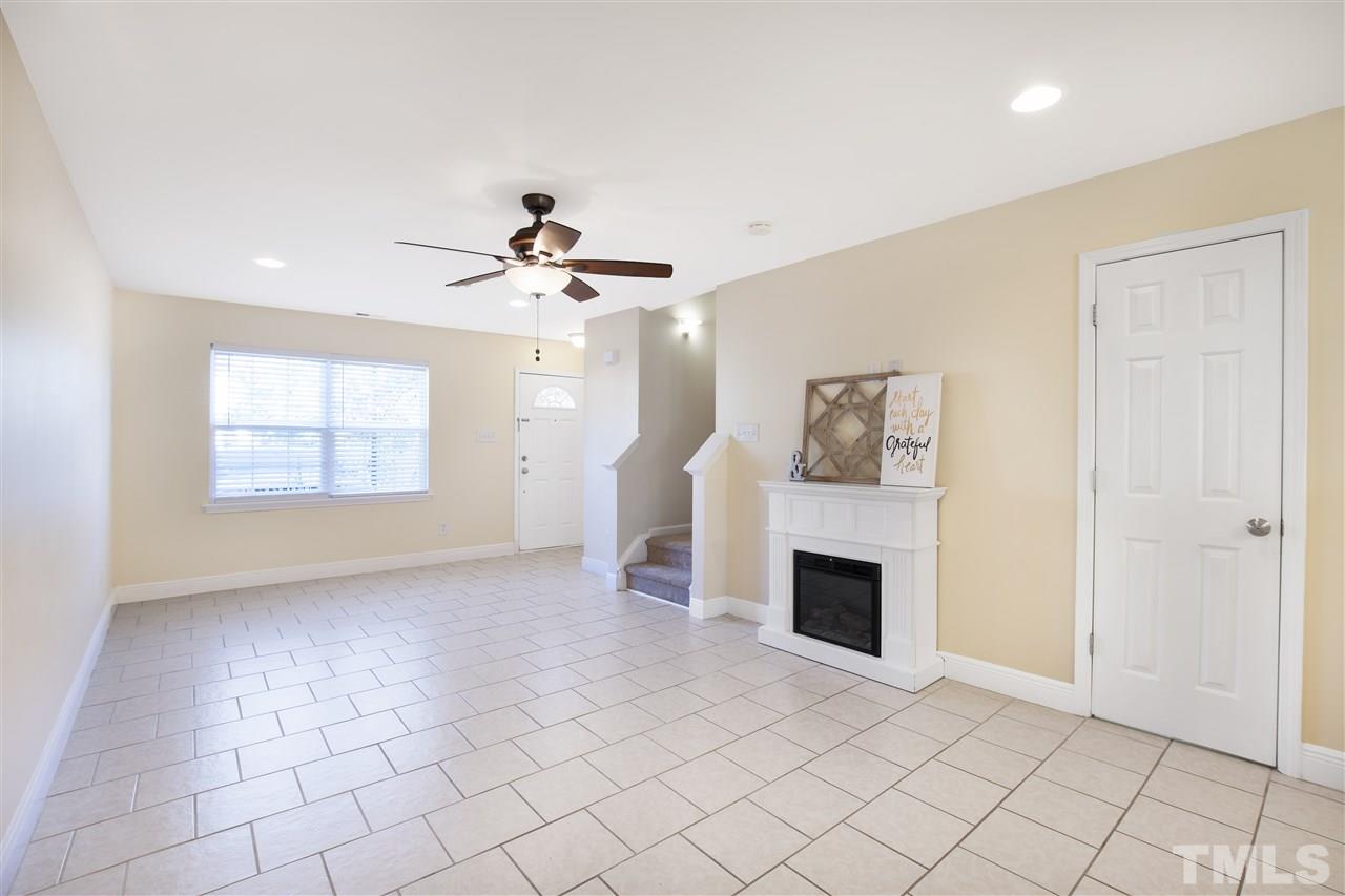 8918 Thornton Garden Lane Raleigh, NC 27616 - Photo 5 of 26 an empty room with fireplace and windows