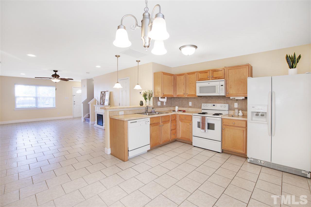 8918 Thornton Garden Lane Raleigh, NC 27616 - Photo 8 of 26 a kitchen with a sink window and cabinets
