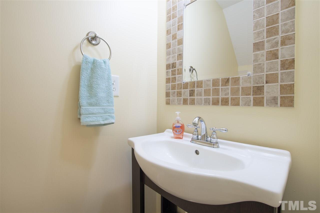 8918 Thornton Garden Lane Raleigh, NC 27616 - Photo 10 of 26 a bathroom with a sink and a mirror