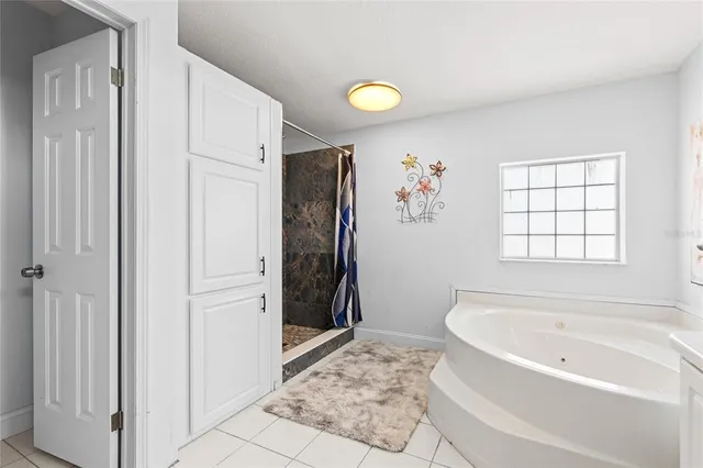 a bathroom with a tub sink and shower