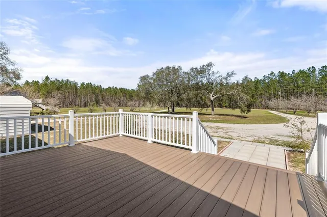a view of balcony with wooden floor and fence