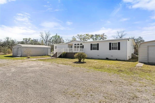 a view of an house with backyard space and balcony