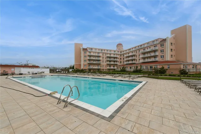 a view of swimming pool with outdoor seating and city view