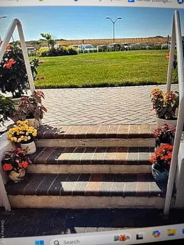 a view of a bench in front of a house