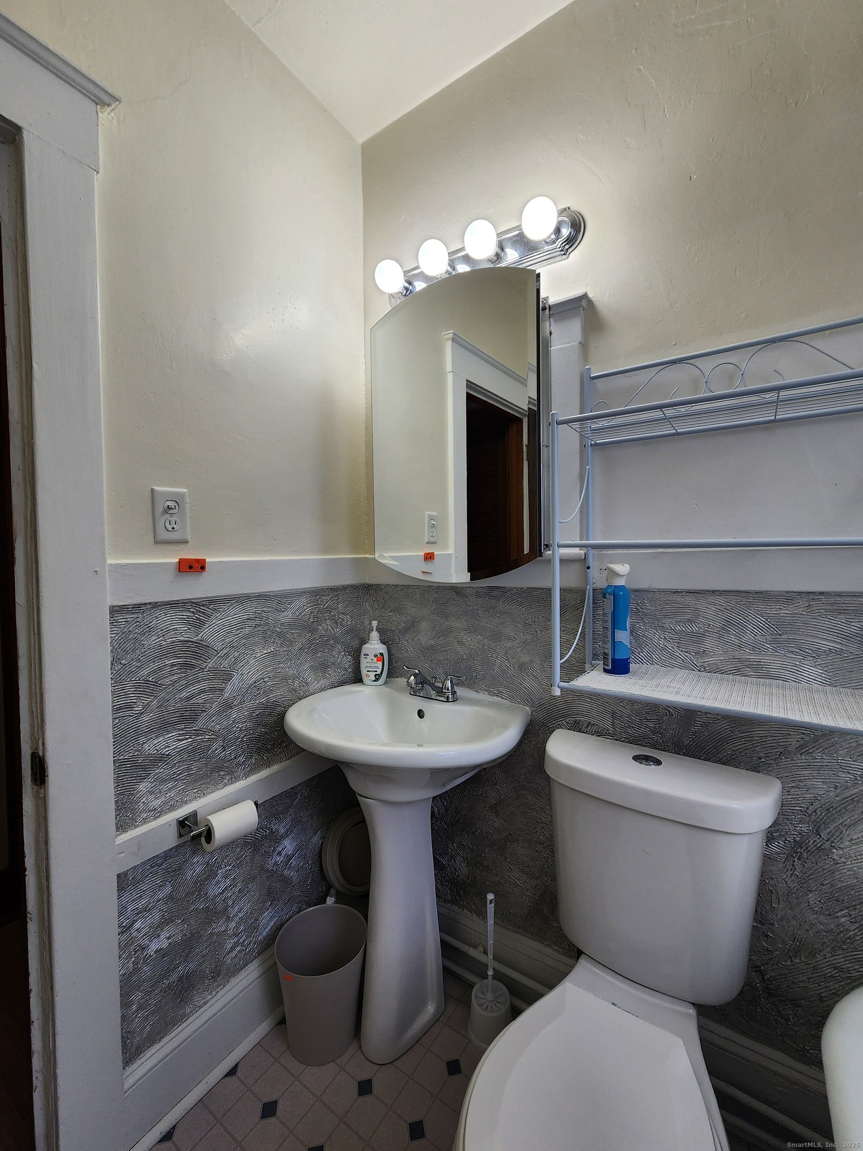 106 Lyons Street New Britain, CT 06052 - Photo 19 of 24 a bathroom with a toilet sink and mirror