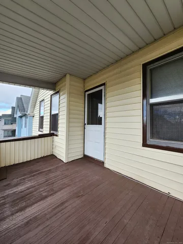 a view of a porch with wooden floors