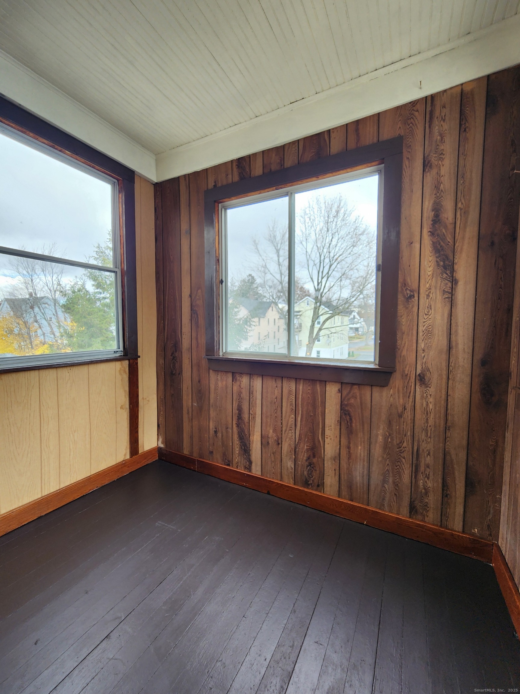 106 Lyons Street New Britain, CT 06052 - Photo 22 of 24 an empty room with wooden floor and windows