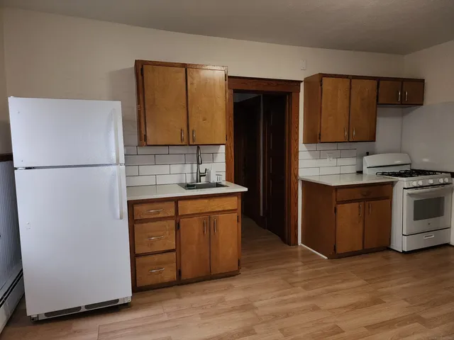 a kitchen with stainless steel appliances granite countertop a refrigerator stove and sink