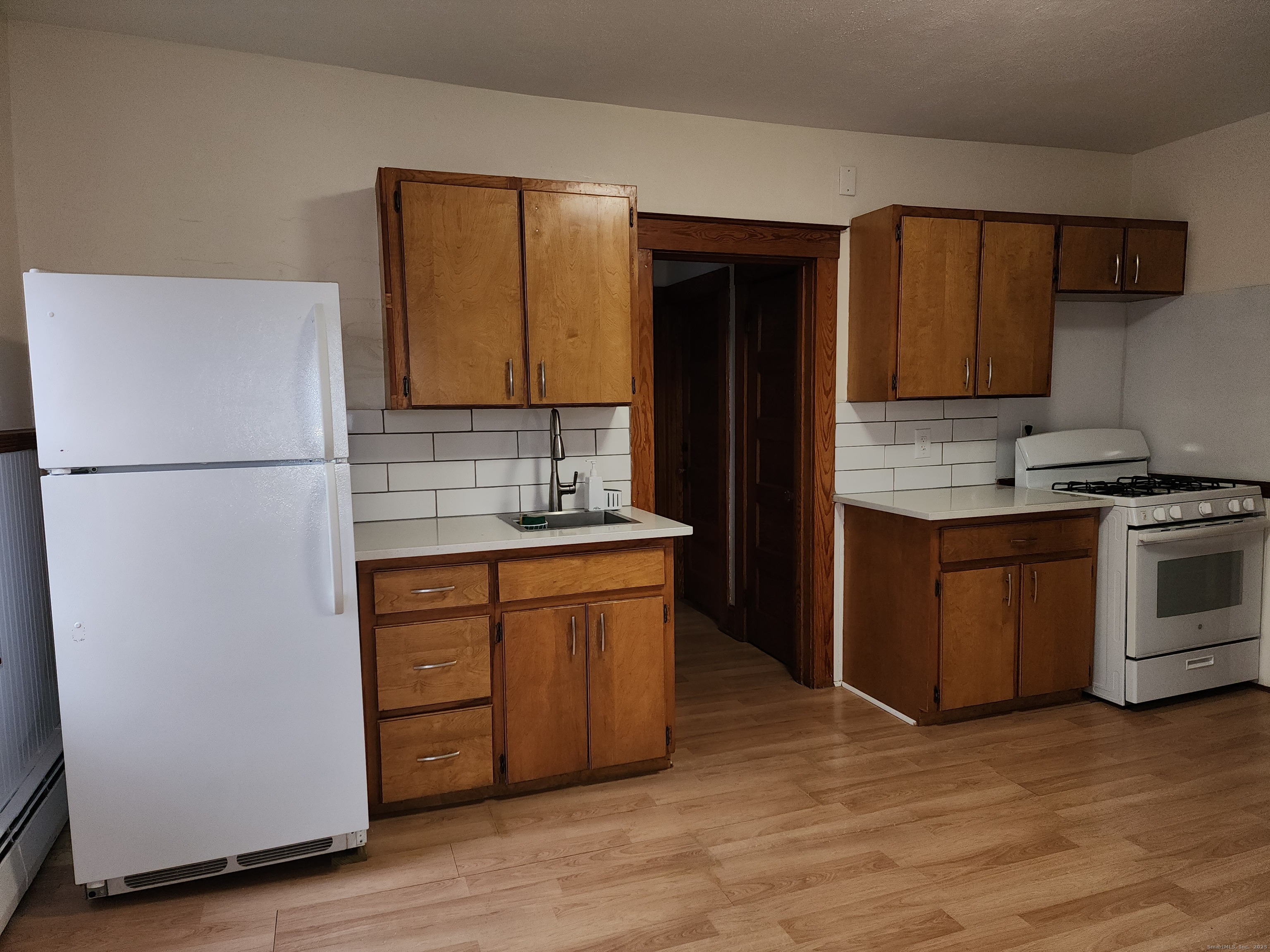106 Lyons Street New Britain, CT 06052 - Photo 3 of 24 a kitchen with stainless steel appliances granite countertop a refrigerator stove and sink