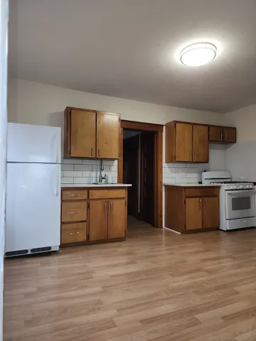 a large kitchen with a stove a sink and a refrigerator