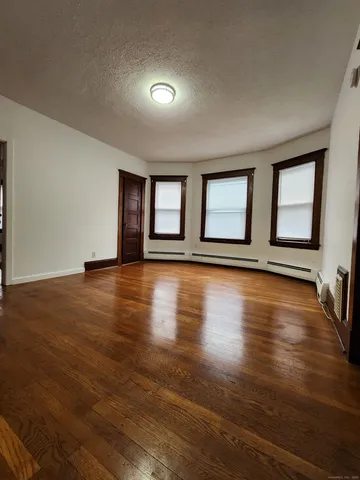 a view of room with window and wooden floor