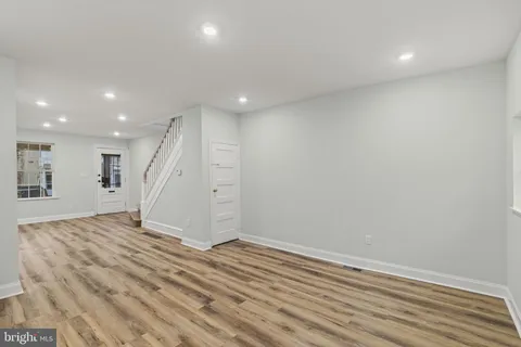 a view of a room with wooden floor