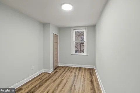 a view of room with window and hardwood floor