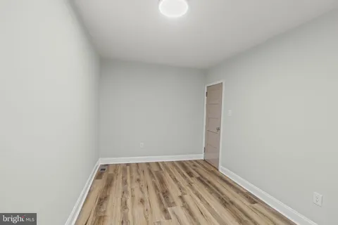 a view of room with wooden floor