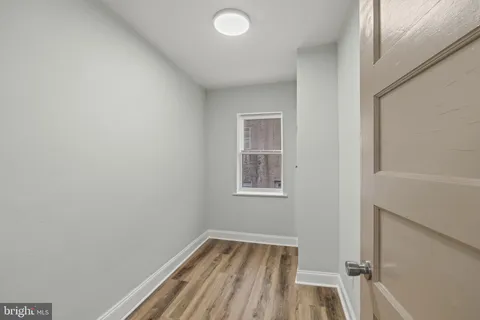 a view of room with window and hardwood floor