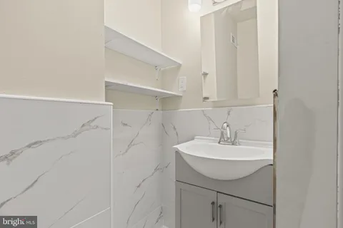 a bathroom with a sink a mirror and shower