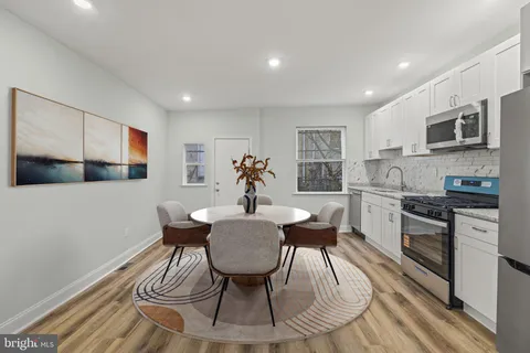 a view of a dining room with furniture wooden floor and kitchen
