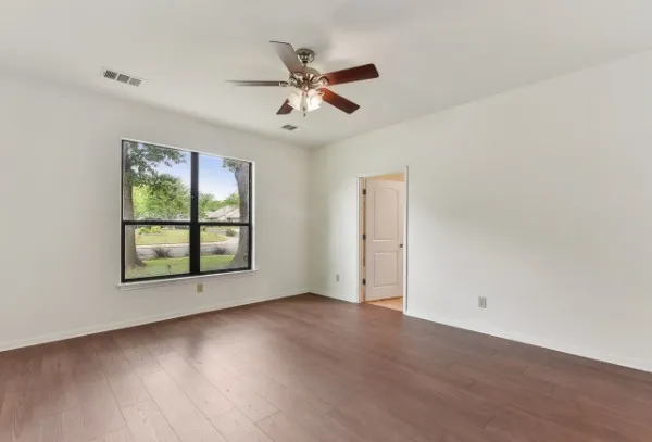 wooden floor in an empty room with a window
