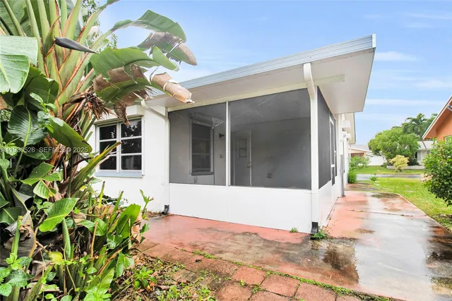 a front view of a house with a yard and a glass top table