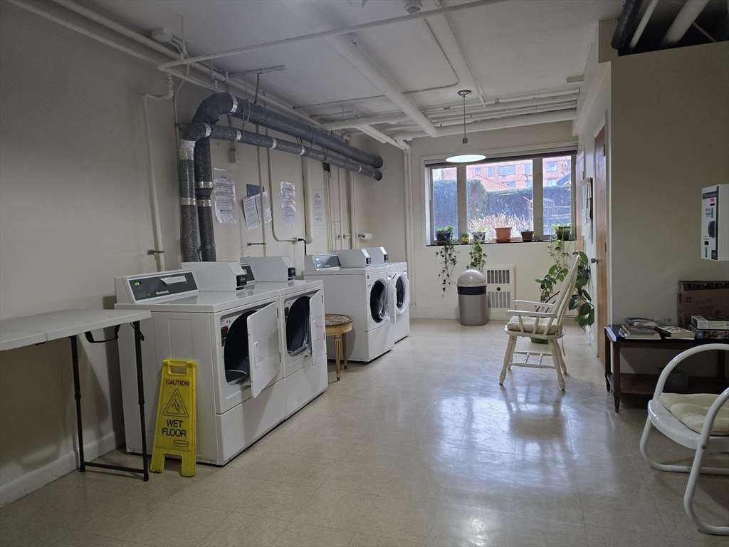 114 Pleasant Street, Unit 306 Arlington, MA 02476 - Photo 15 of 16 a view of a kitchen with stainless steel appliances granite countertop a stove and a refrigerator