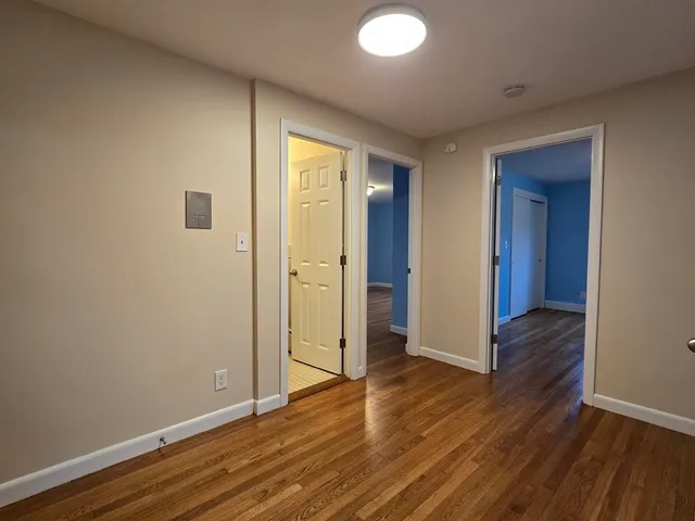 a view of hallway with wooden floor