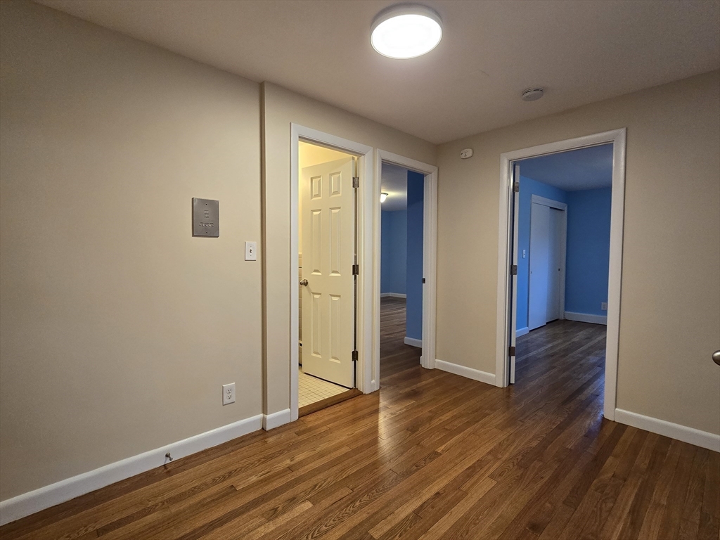 114 Pleasant Street, Unit 306 Arlington, MA 02476 - Photo 2 of 16 a view of hallway with wooden floor