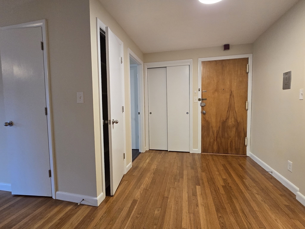 114 Pleasant Street, Unit 306 Arlington, MA 02476 - Photo 8 of 16 a view of a hallway with wooden floor