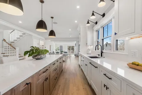 a large kitchen with stainless steel appliances lots of counter space and a sink