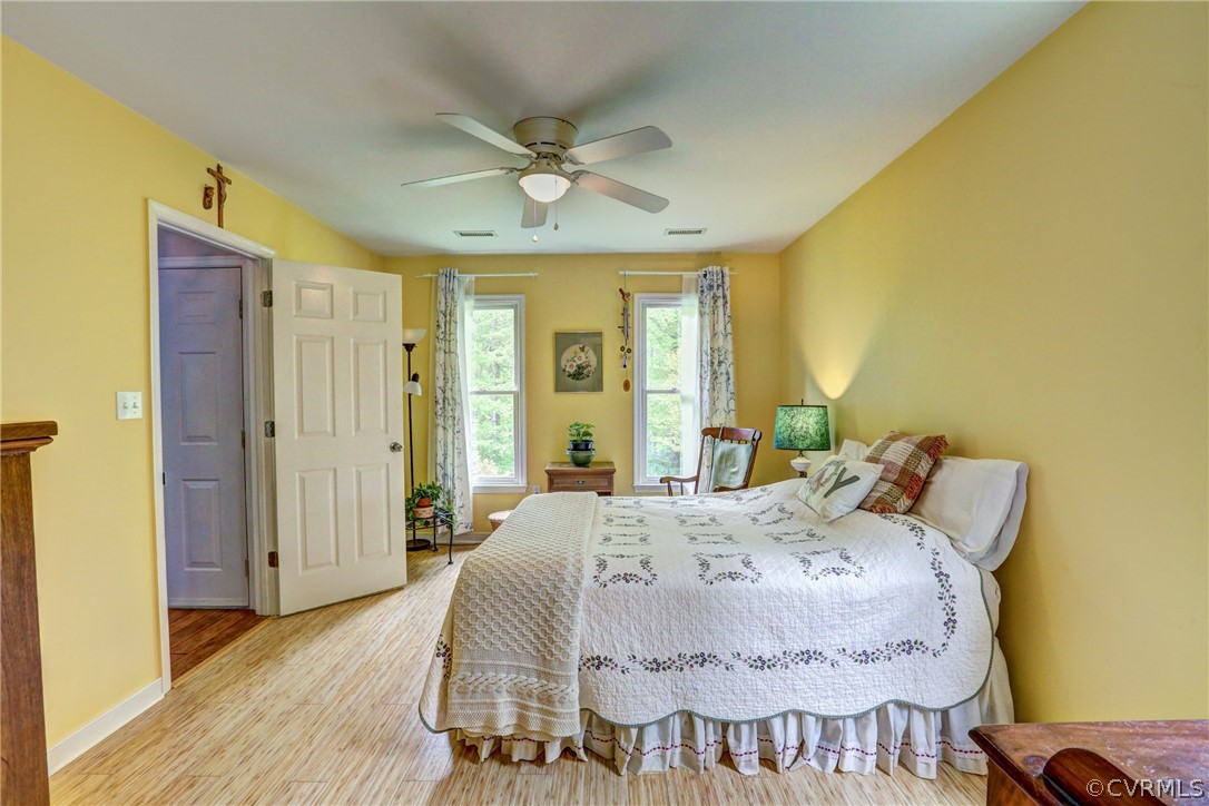 4151 Broad St Road Gum Spring, VA 23065 - Photo 21 of 38 a spacious bedroom with a bed and wooden floor