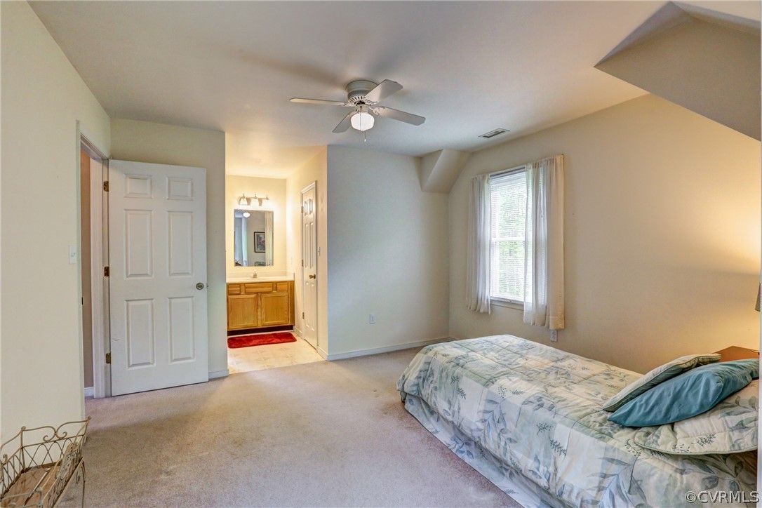 4151 Broad St Road Gum Spring, VA 23065 - Photo 24 of 38 a bedroom with a bed and a chandelier