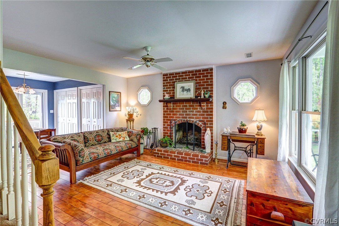 4151 Broad St Road Gum Spring, VA 23065 - Photo 6 of 38 a living room with furniture a fireplace a clock and a large window