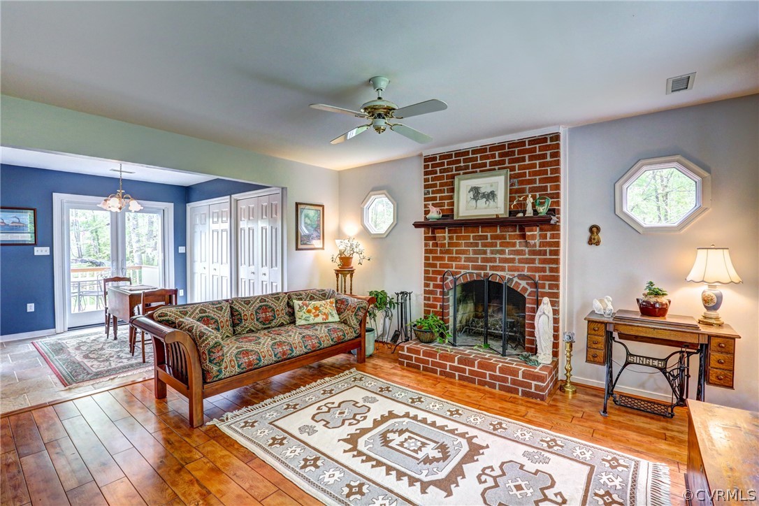 4151 Broad St Road Gum Spring, VA 23065 - Photo 8 of 38 a living room with furniture a fireplace and a table