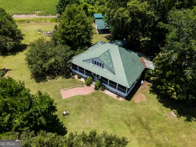 a view of a back yard of the house with a yard