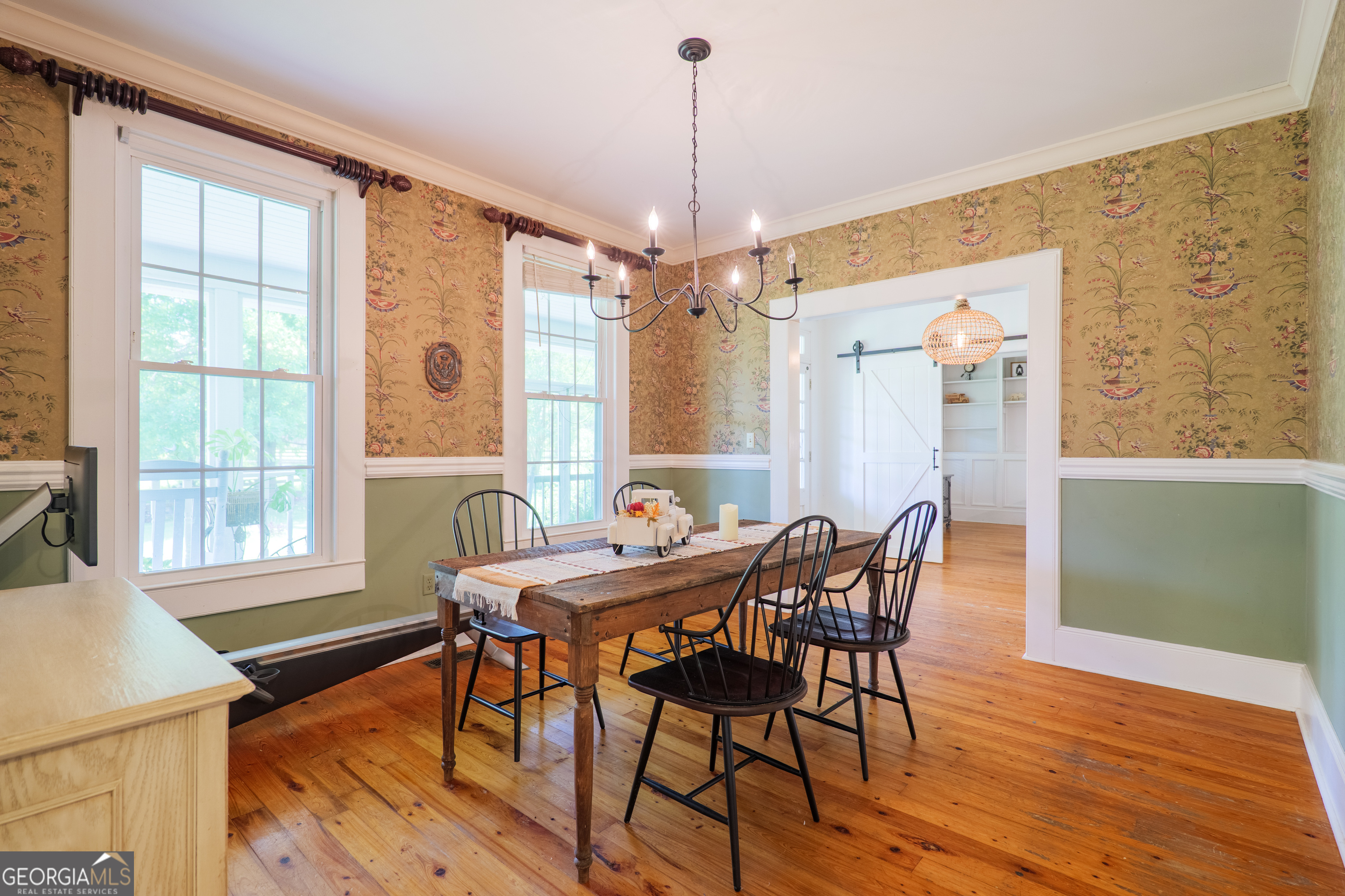 7552 Webb Road Hahira, GA 31632 - Photo 11 of 57 a dining room with furniture a chandelier and wooden floor