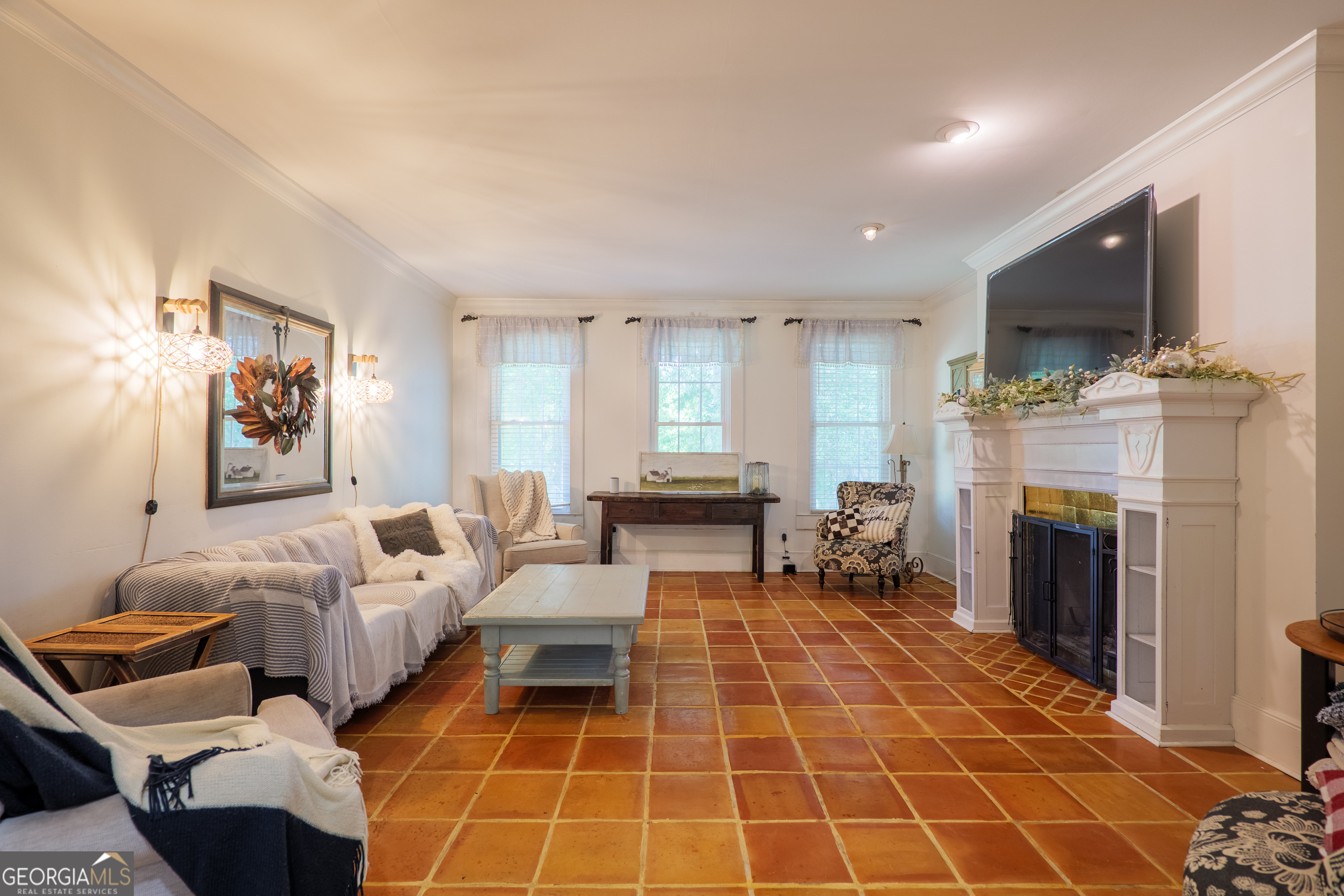 7552 Webb Road Hahira, GA 31632 - Photo 12 of 57 a living room with furniture a flat screen tv and a fireplace