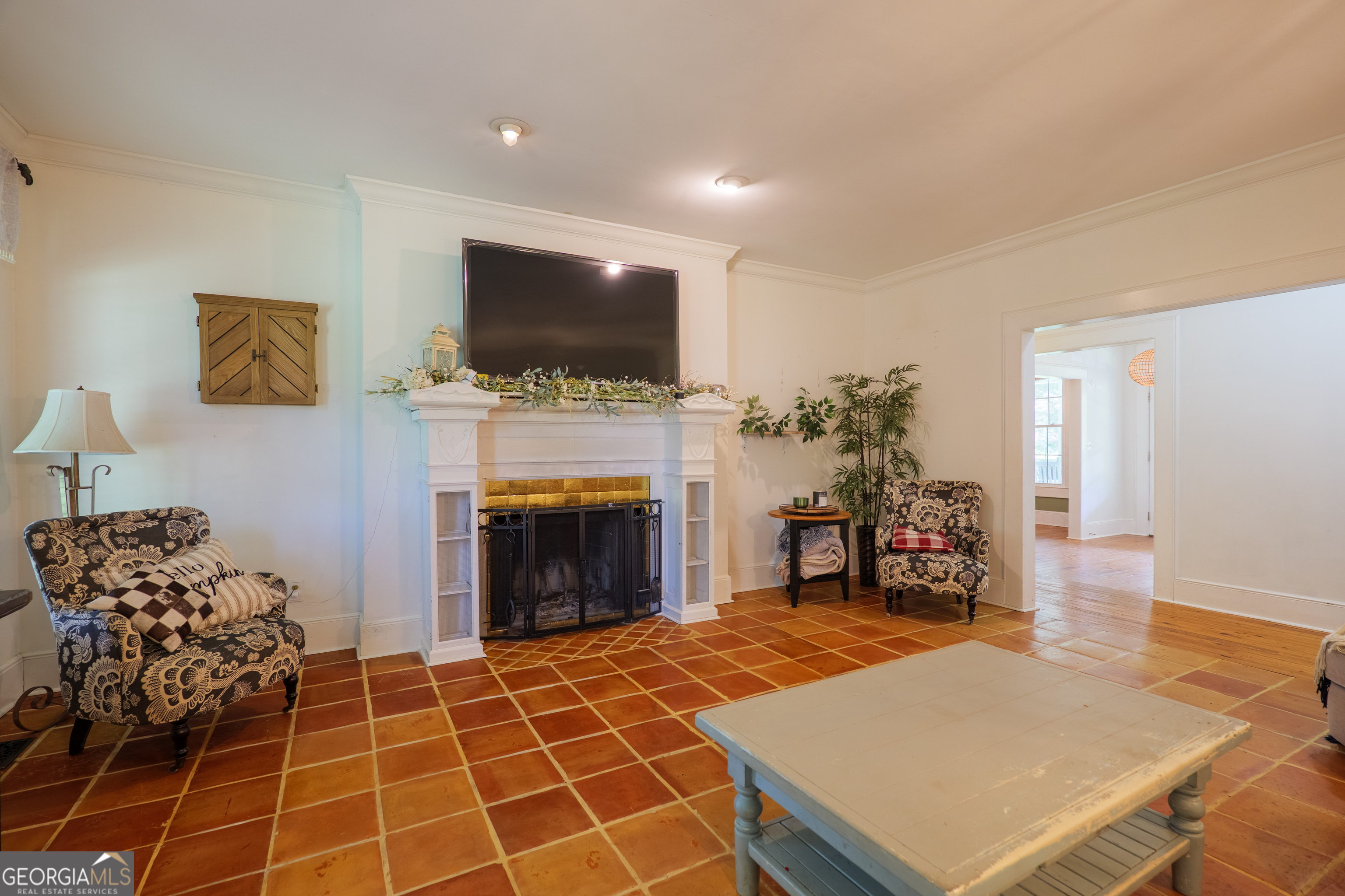 7552 Webb Road Hahira, GA 31632 - Photo 13 of 57 a living room with furniture a flat screen tv and a fireplace