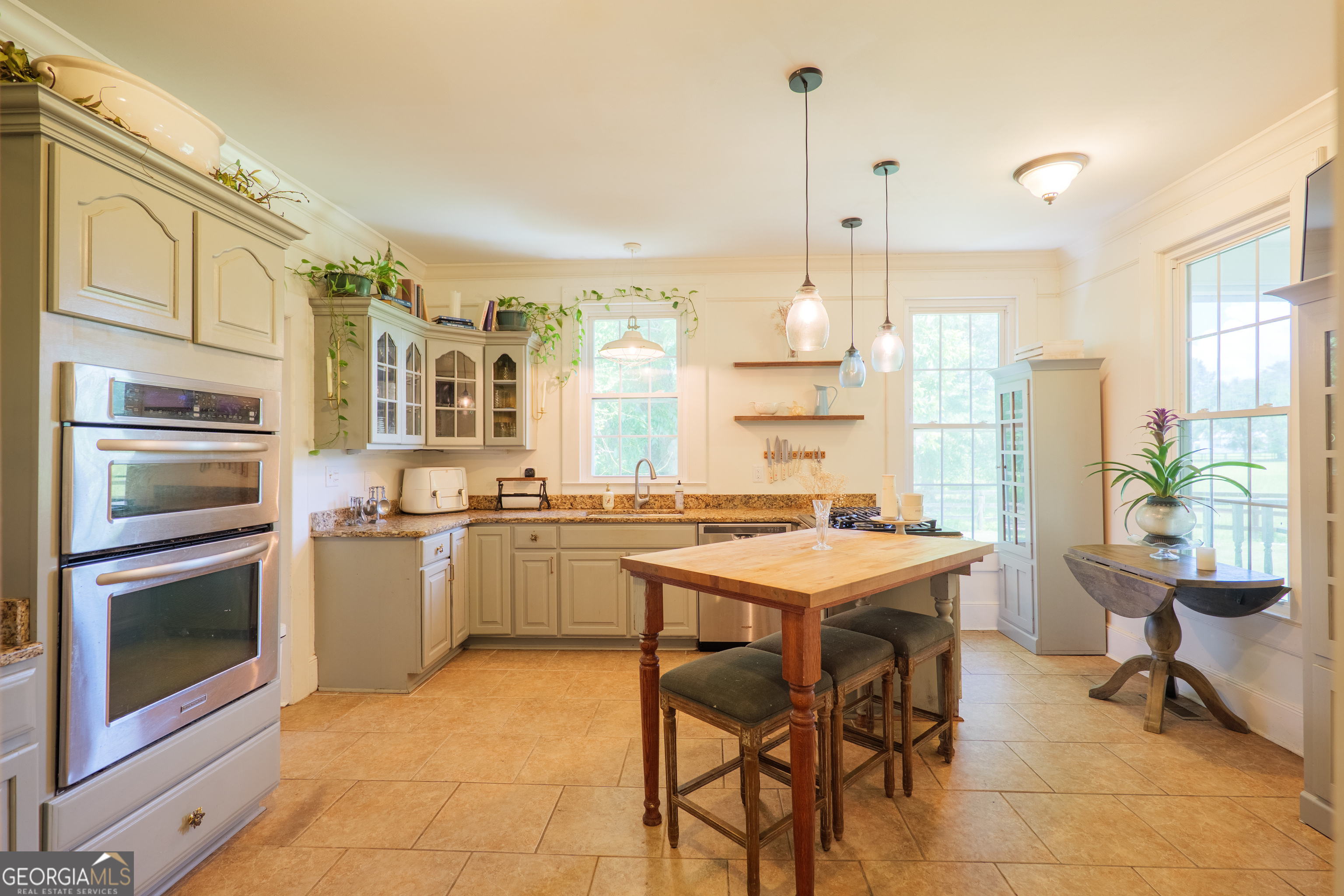 7552 Webb Road Hahira, GA 31632 - Photo 14 of 57 a kitchen with a stove a refrigerator and a dining table