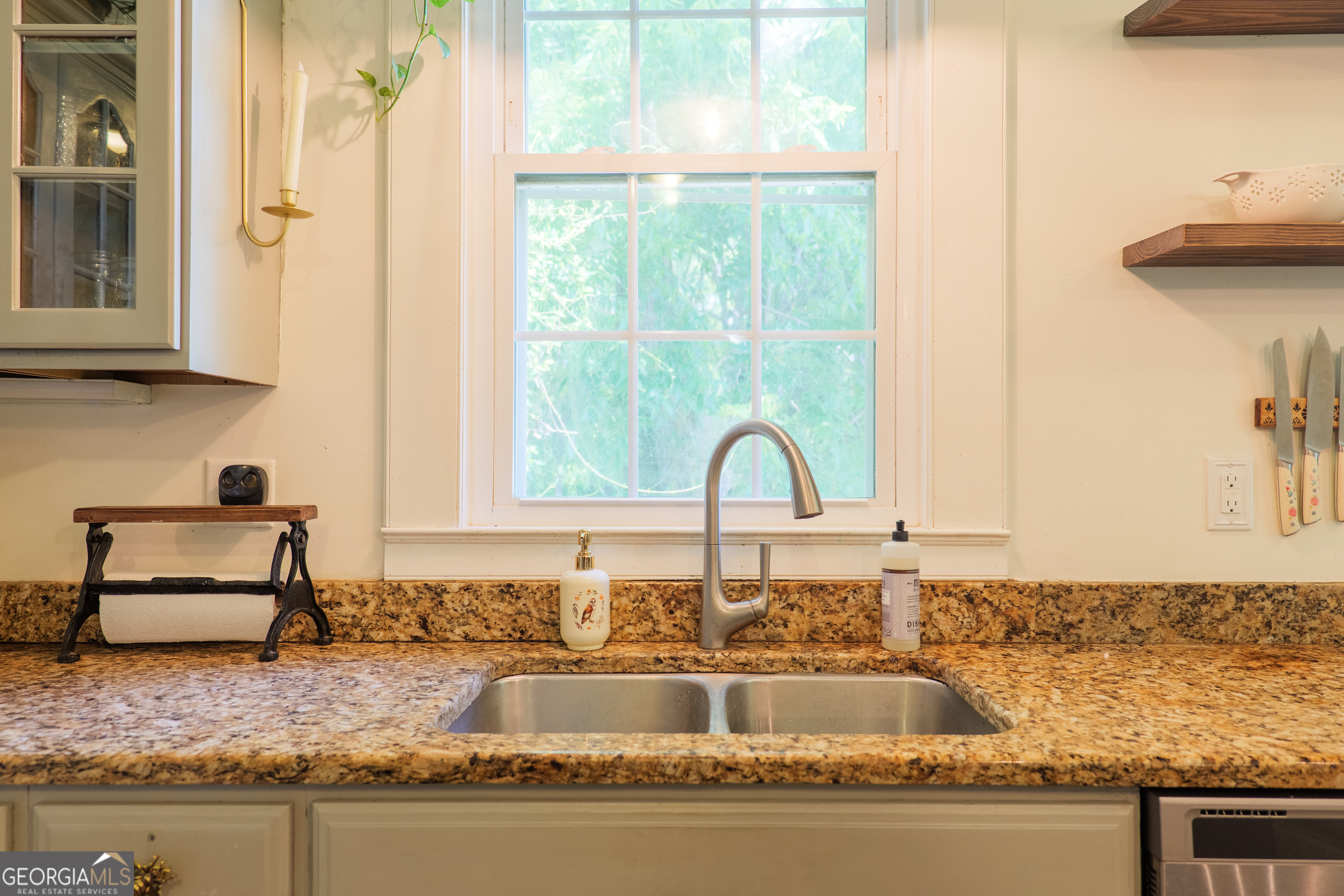 7552 Webb Road Hahira, GA 31632 - Photo 18 of 57 a kitchen with granite countertop a sink and a window